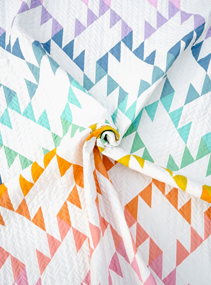 Jenny Quilt Pattern made with Pure Solids fabrics in a vibrant rainbow color scheme